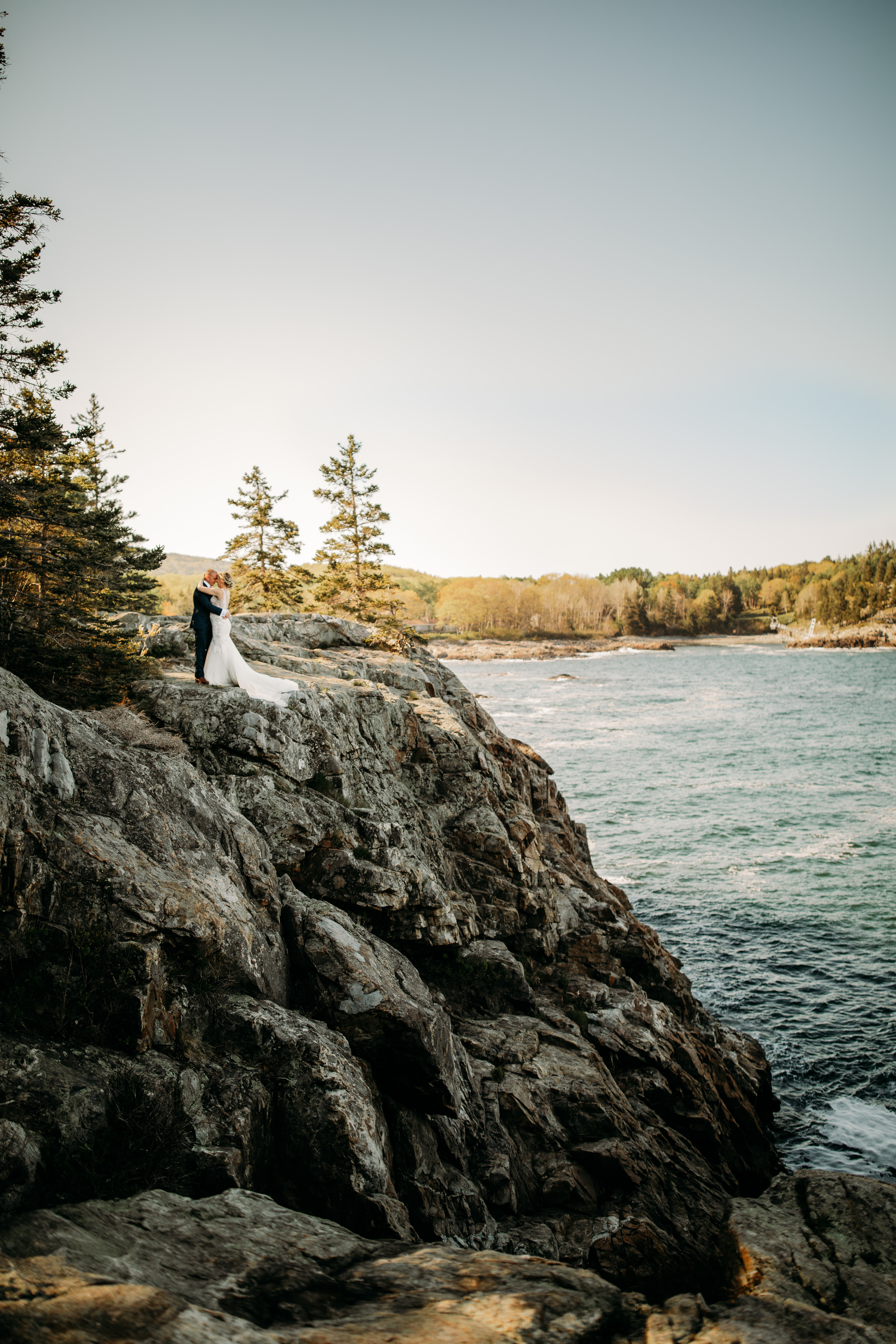 Couple standing on a cliff at Schooner Head Outlook at Acadia National Park in Bar Harbor Maine with ocean and woodsy vibes. Maine elopement and wedding photographer 