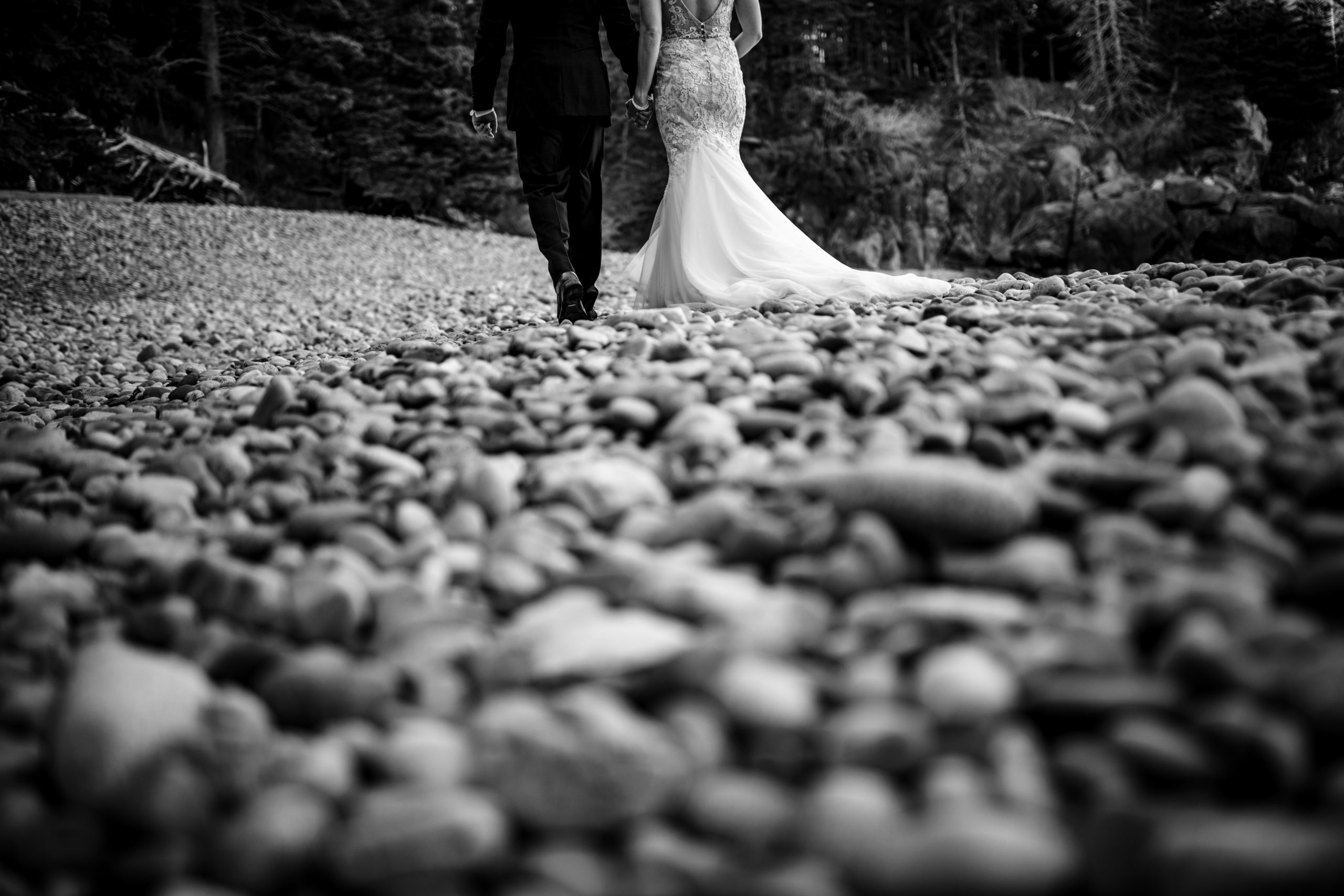 Acadia national park, Little Hunters Beach Elopement. Couple walking away from the camera with a creative angle in black and white maine wedding photographer
