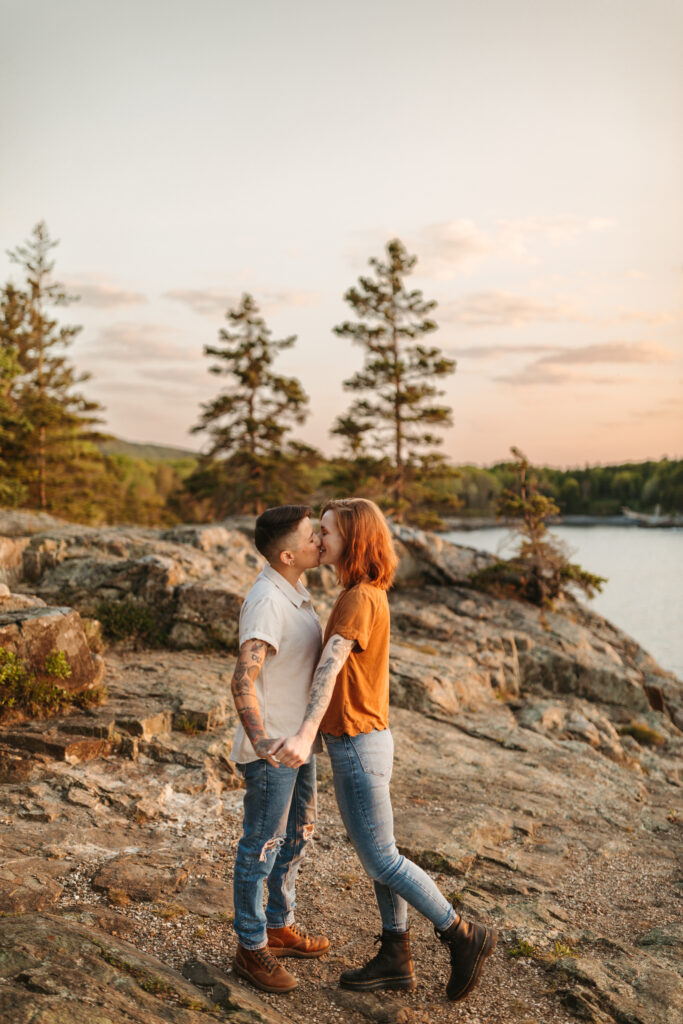 couple kissing on the cliffs at acadia national park lgbtq maine proposal