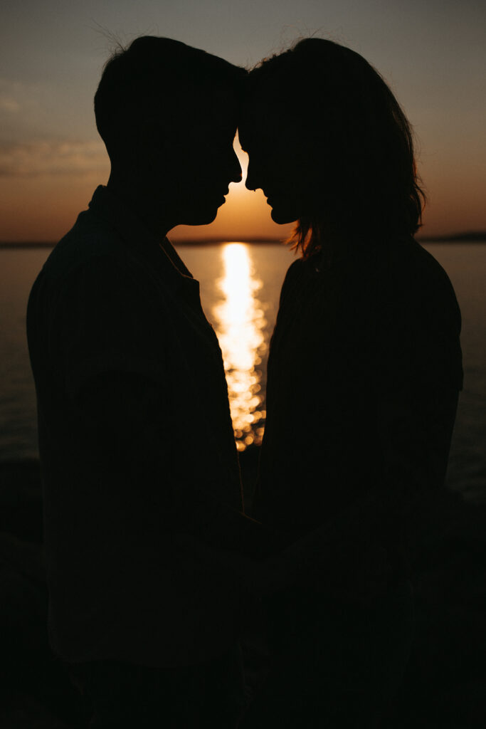 silhouette photo of two women in love touching foreheads together for their engagement photos