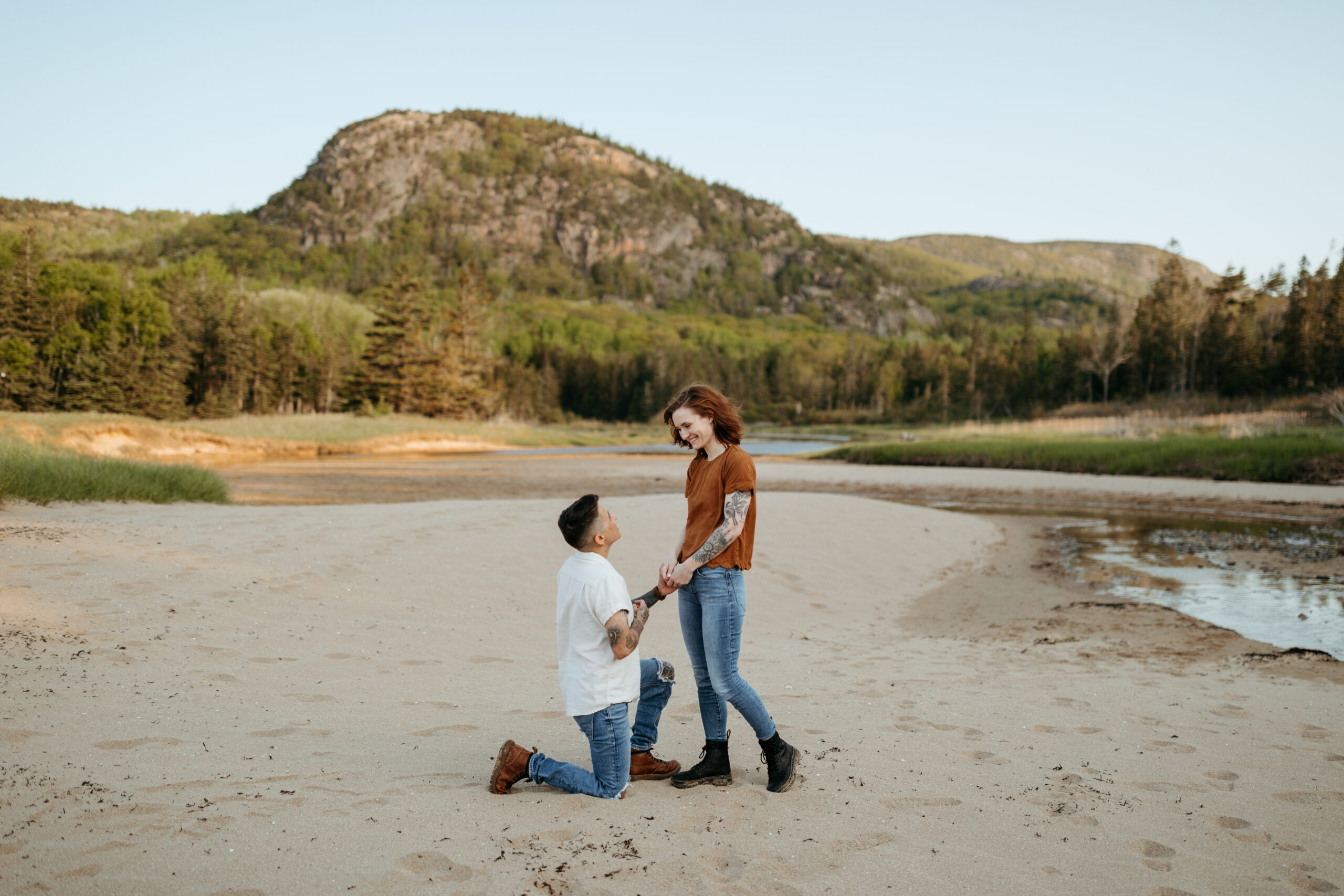 lgbtq proposal between two women on sand beach in acadia national park 