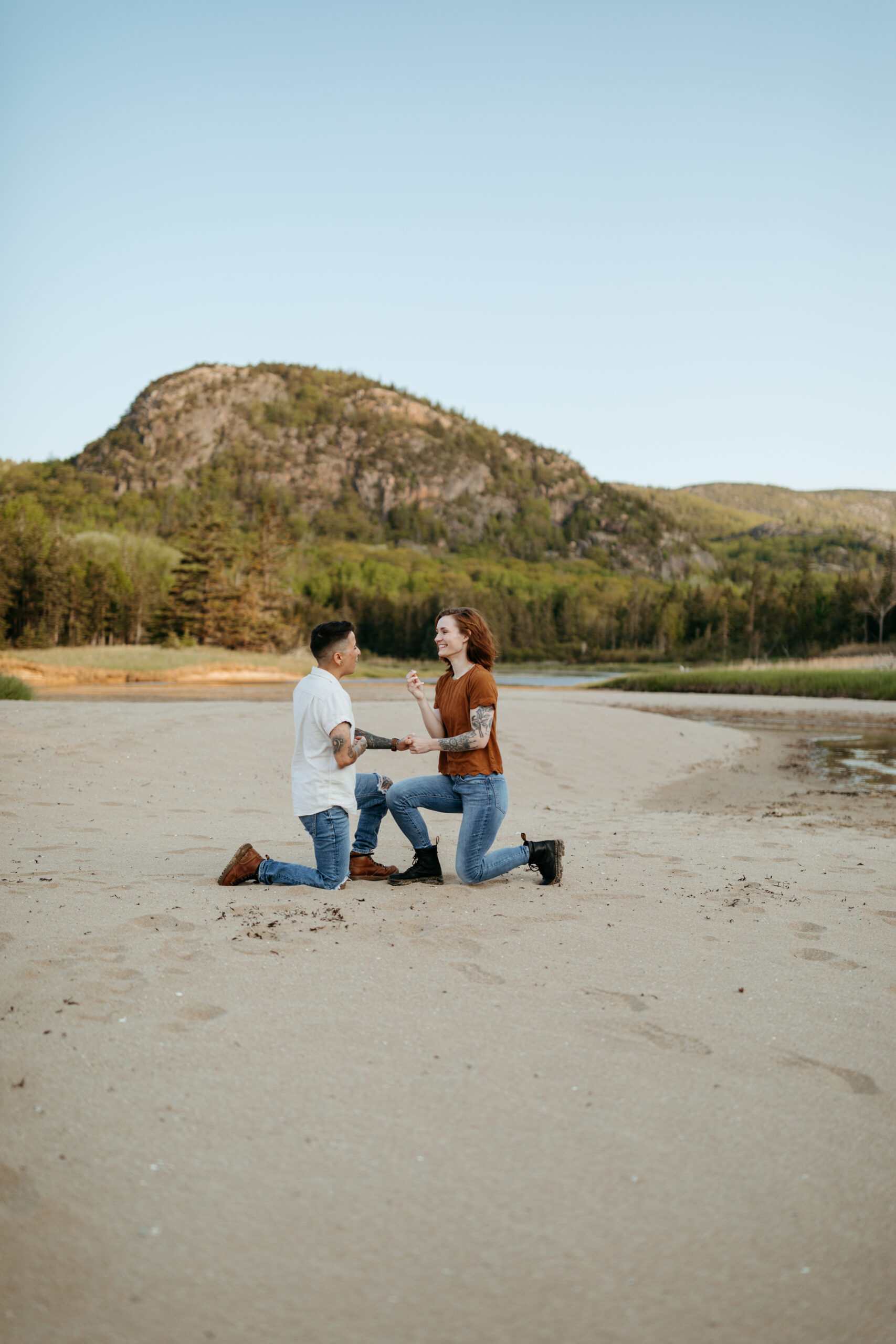 lgbtq proposal between two women on sand beach in acadia national park 