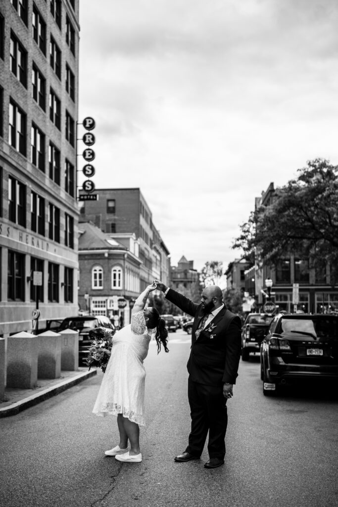 Couple dancing in the streets for their Portland Maine city Hall elopement in the Old Port outside of the Press Hotel in Portland Maine