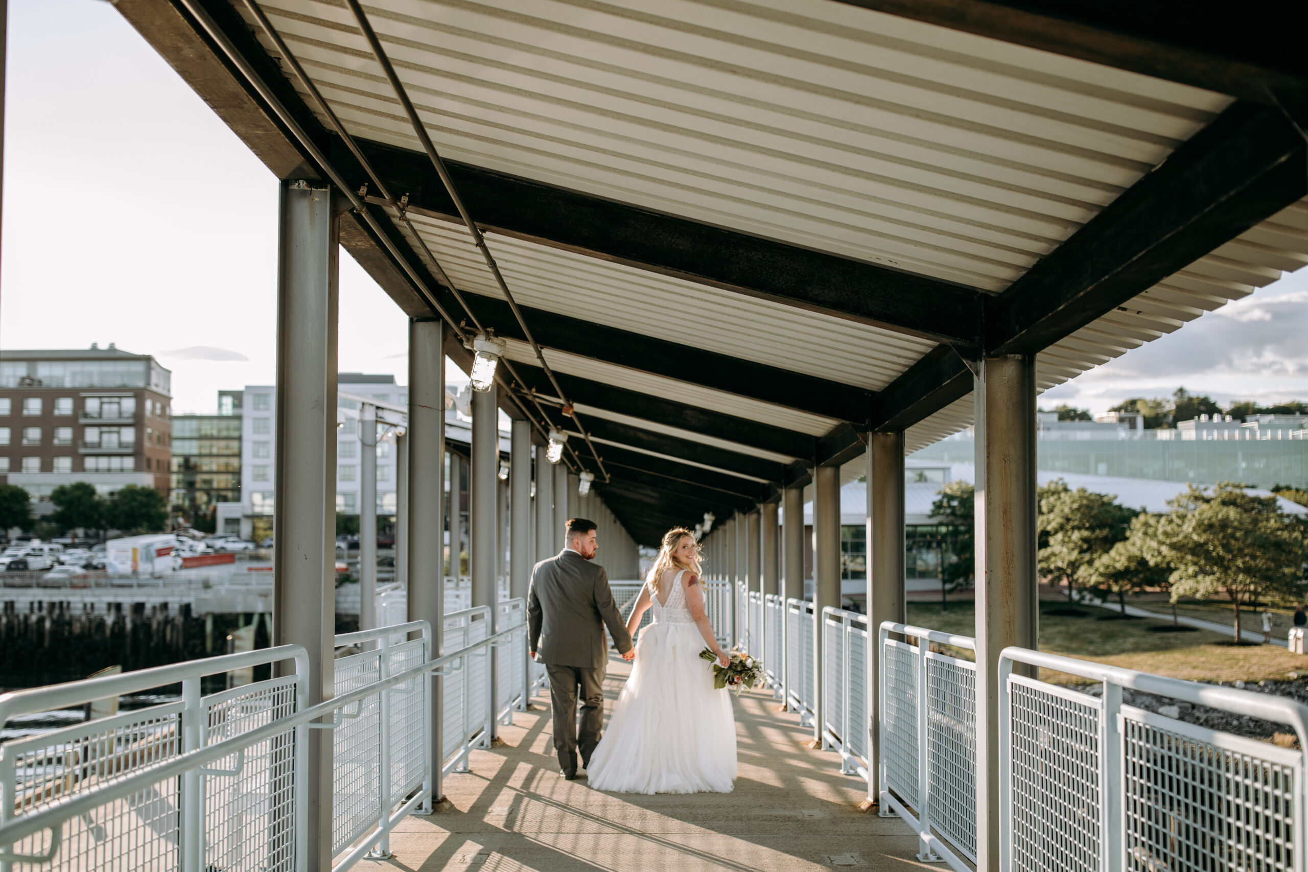 Bride and groom walk down the ramp at the Portland Ocean Gateway in Portland Maine