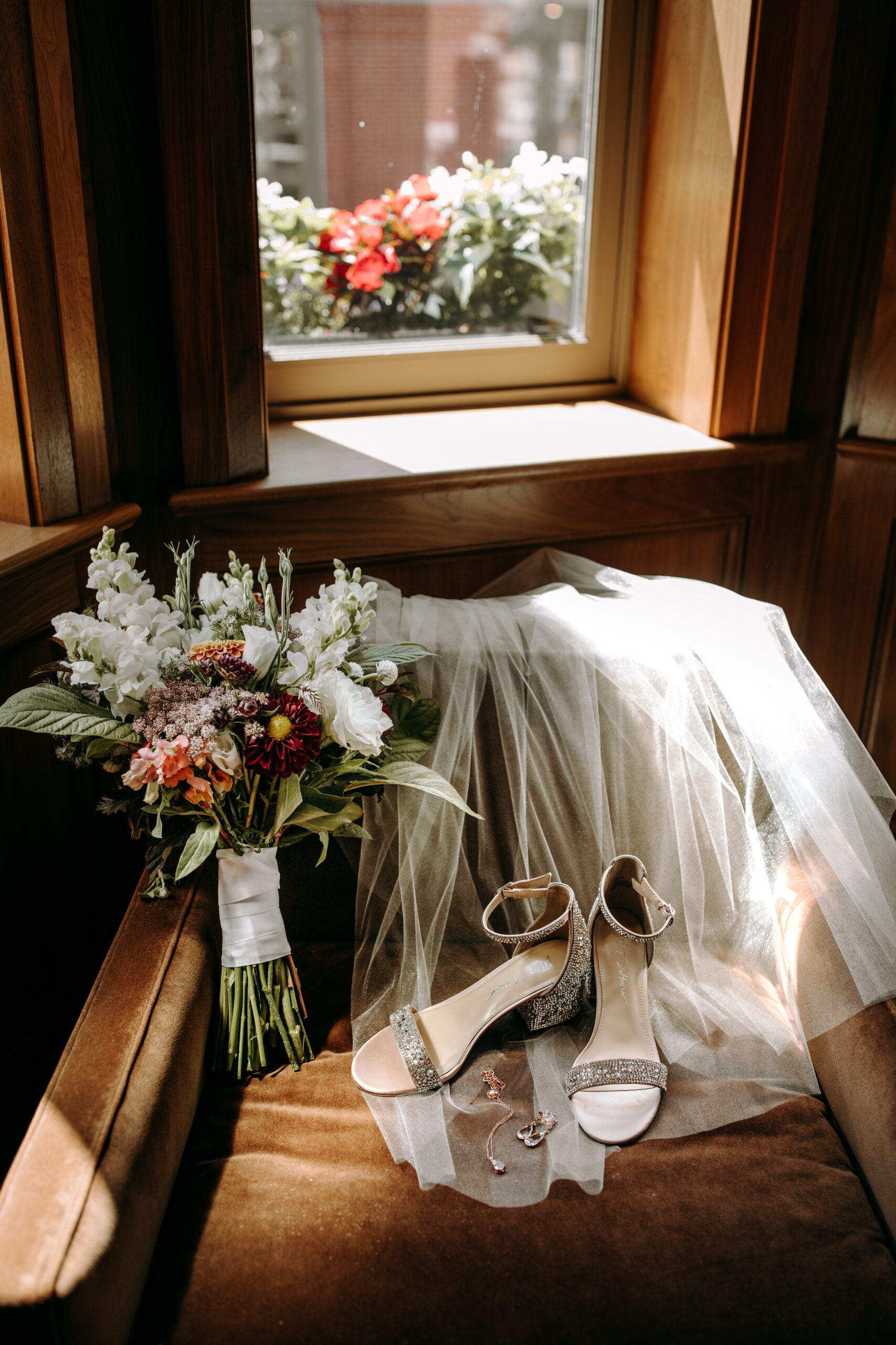 bridal bouquet, wedding shoes, jewelry, veil draped over chair for documentary style detail photos