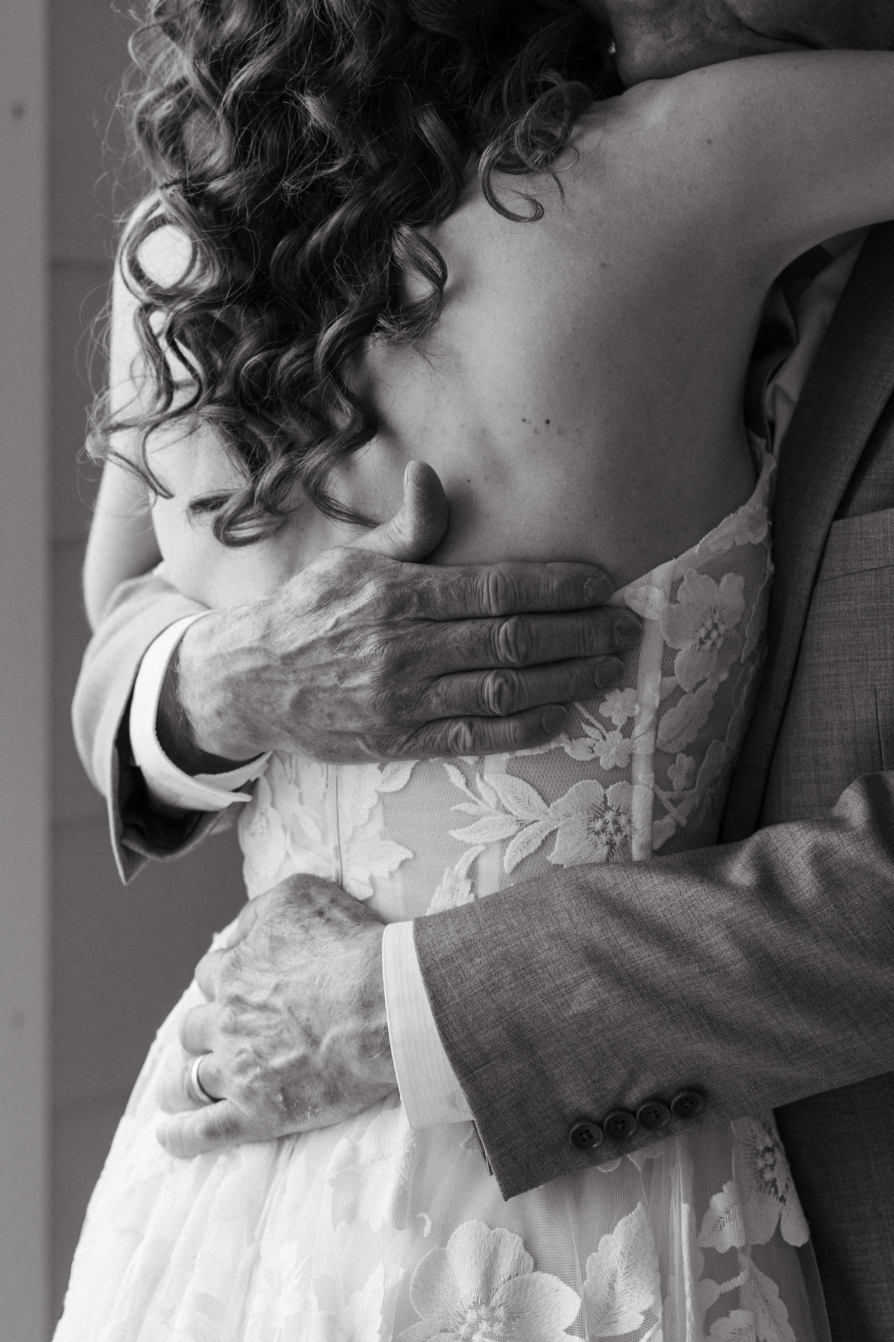 brides first look with dad at the cliff house in york maine close up of hands for a hug 