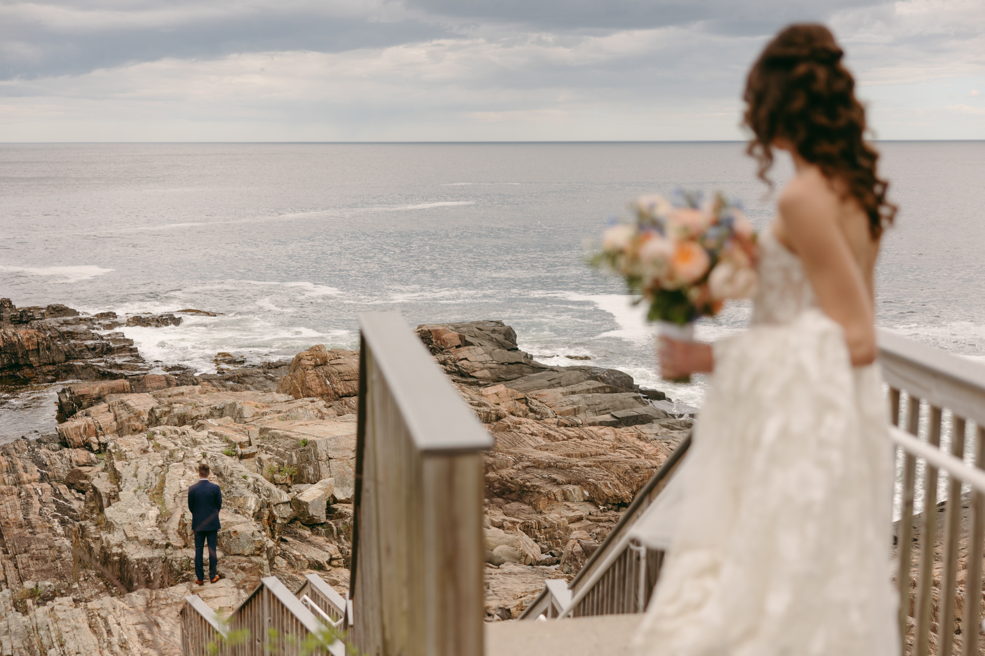 groom waiting for the first look on the cliffs of maine at the cliff house wedding venue in york maine 