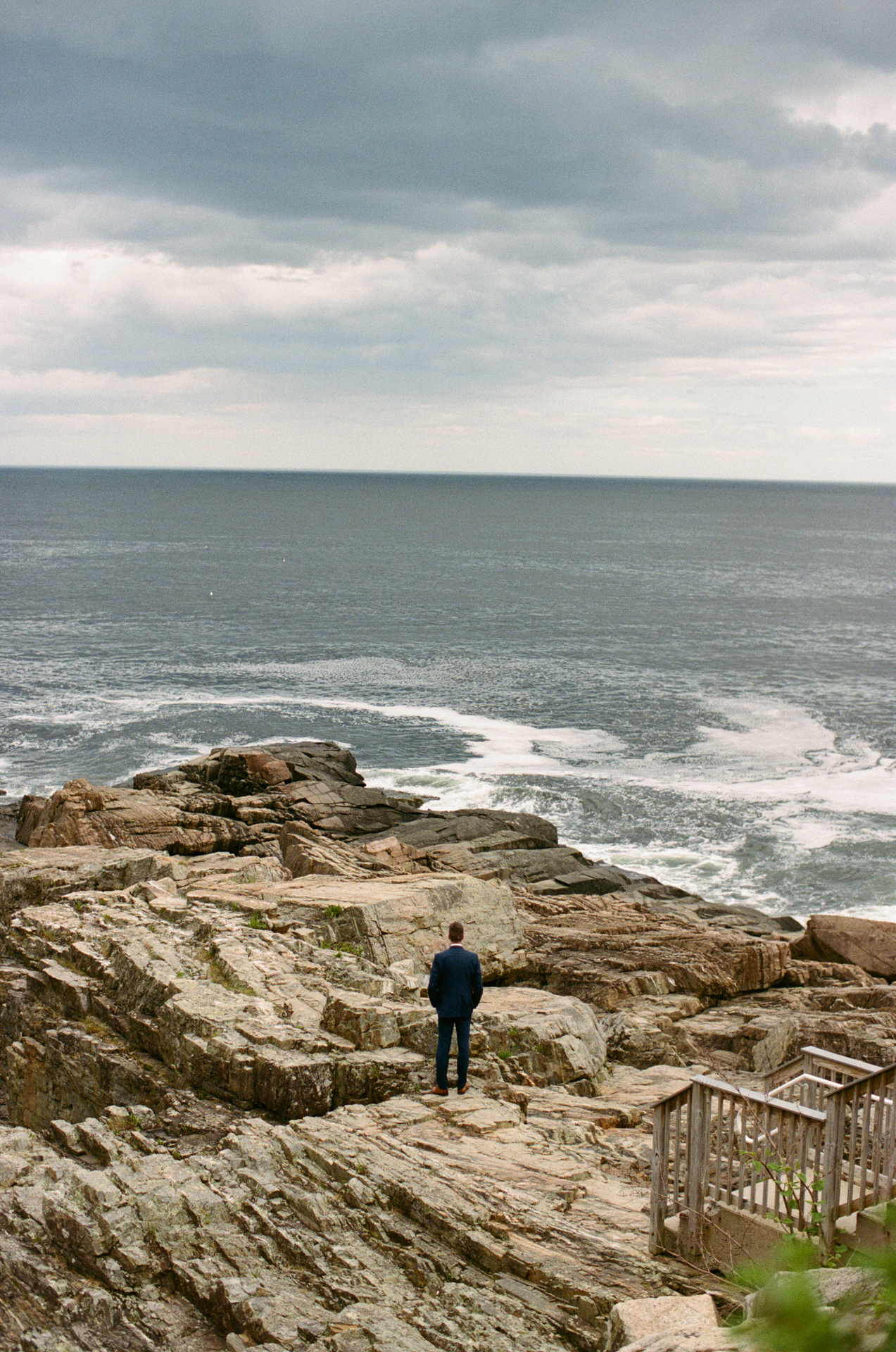 groom waiting for the first look on the cliffs of maine at the cliff house wedding venue in york maine 