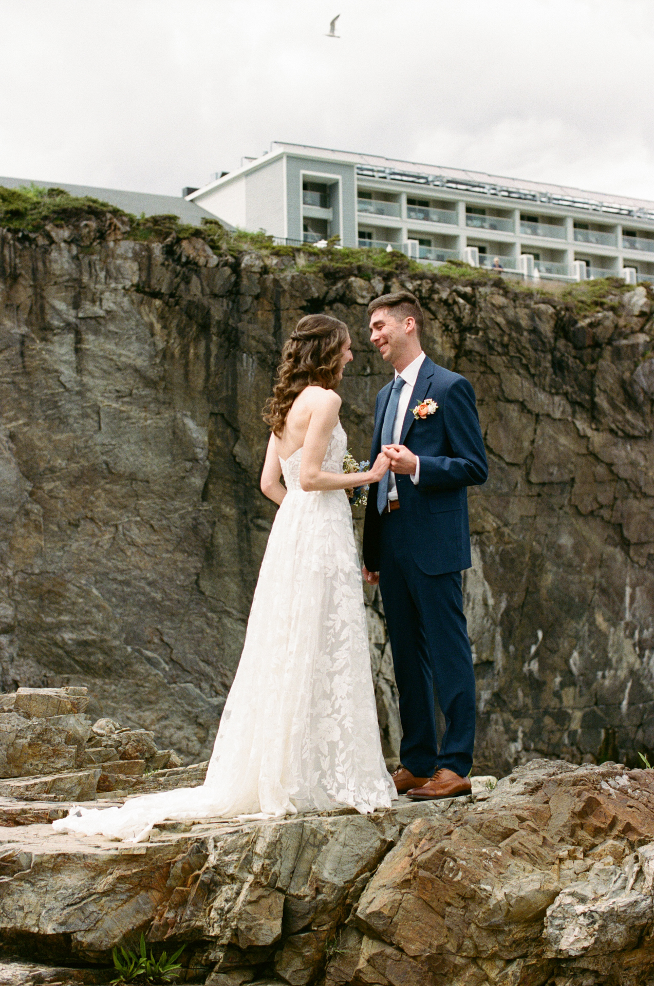 the first look on the cliffs at cliff house maine wedding venue in york maine on 35mm film 