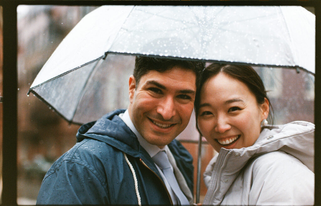 35mm film rainy wedding day portrait with an umbrella