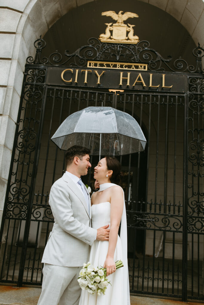 couple in front of Portland Maine city hall sign