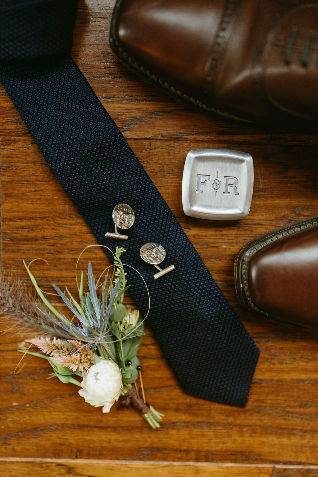 detail photos of tie, cufflinks, boutonniere & shoes