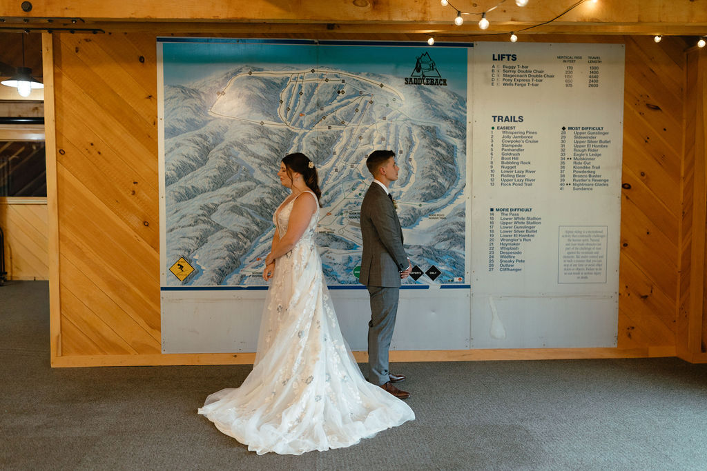 brides standing back to back before first look 