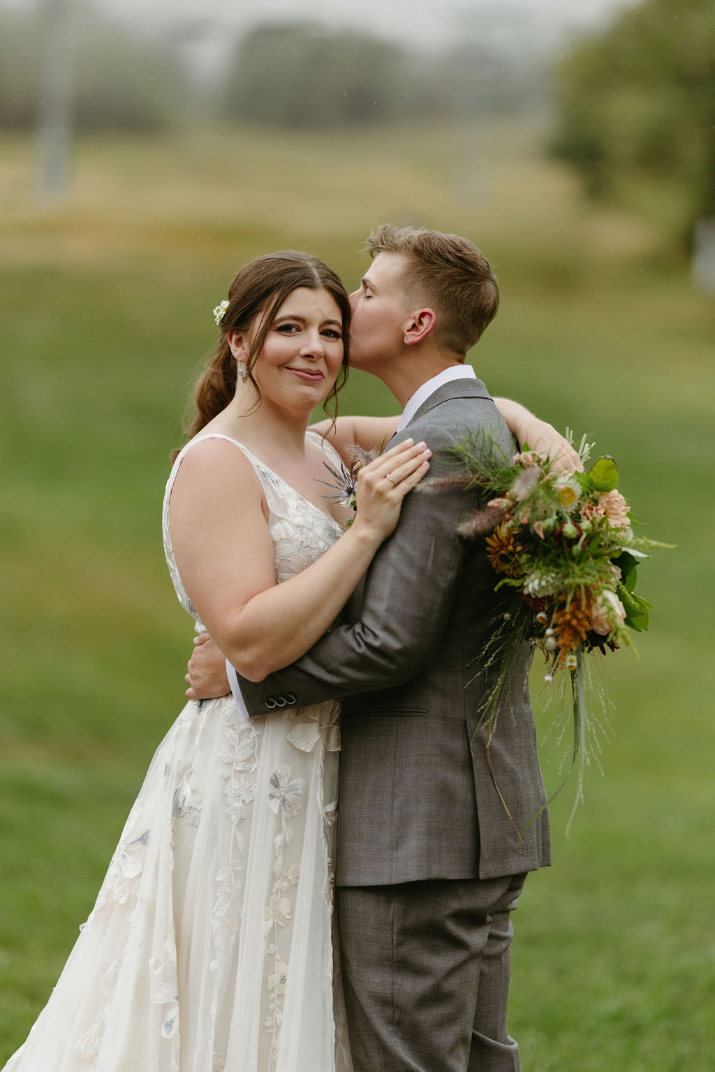 kissing forehead photo with ski lift mountain behind them at Saddleback Mountain in Rangeley, Maine 