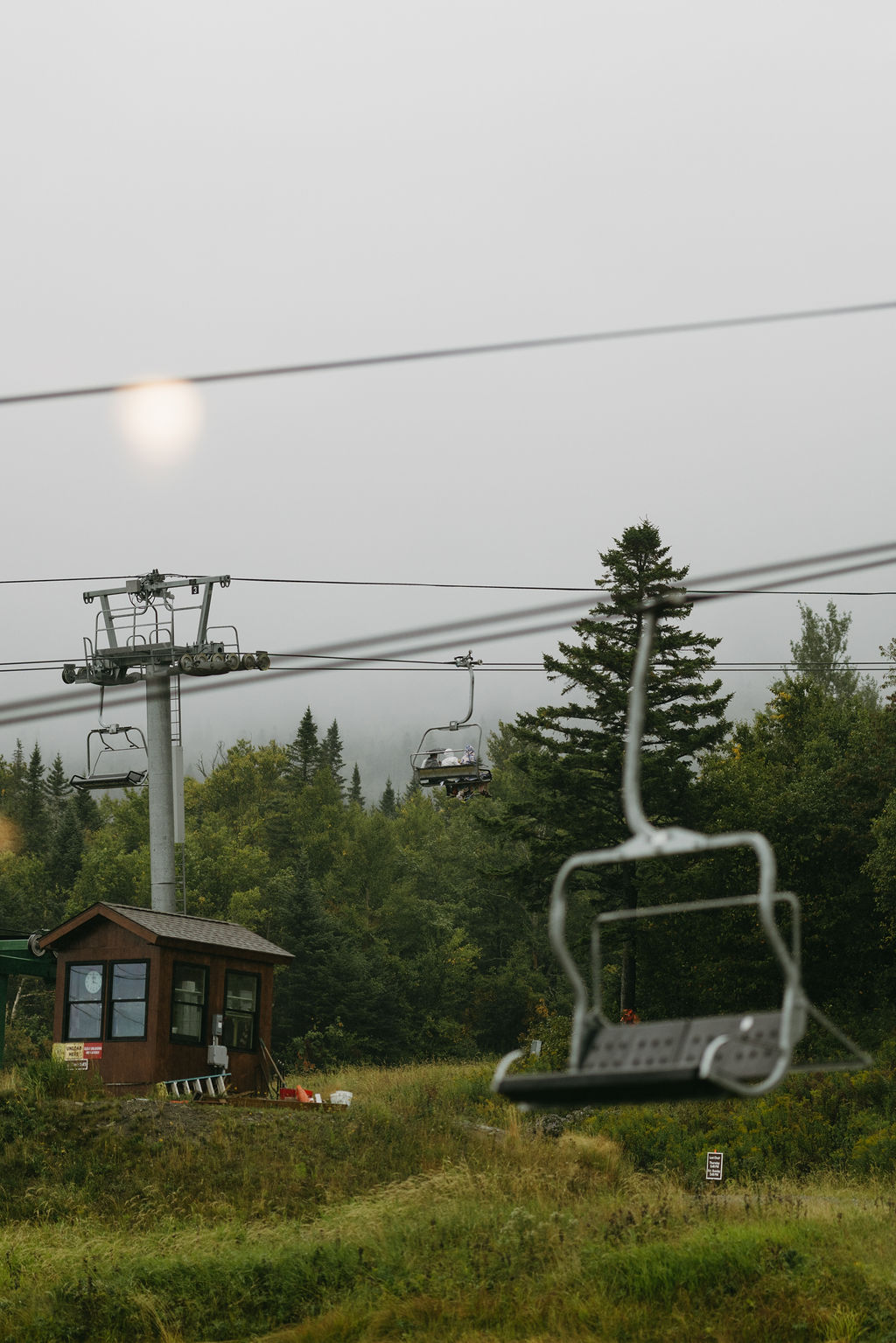 wedding guests in poncho's walking to ski-lift for saddleback maine wedding ceremony