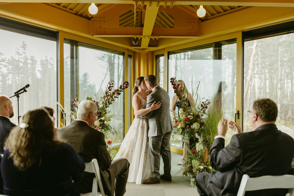 Photo of brides kissing at their ceremony at The Nest at Saddleback Mountain Ski Resort in Rangeley, Maine 