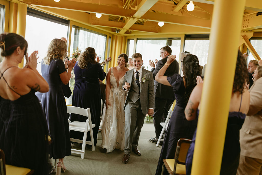Photo of brides walking out of their ceremony at The Nest at Saddleback Mountain Ski Resort in Rangeley, Maine