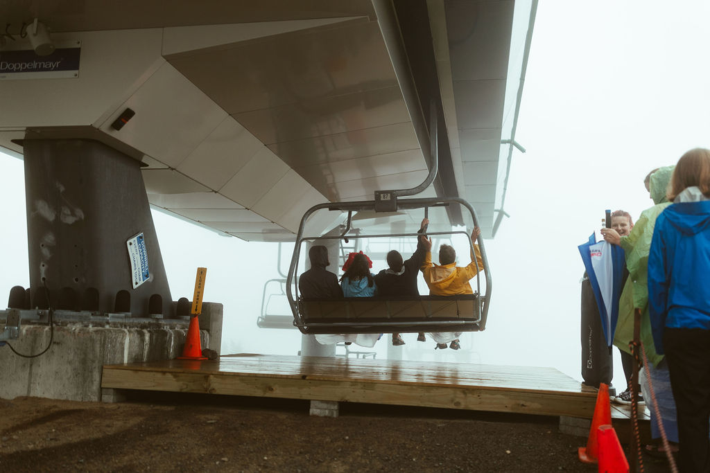 Wedding guests riding ski lift at Saddleback Mountain Maine Wedding 
