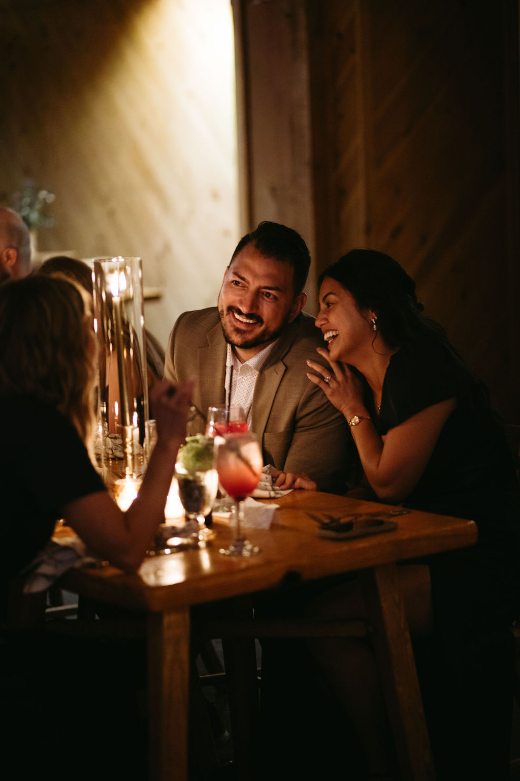 candid, documentary style photograph of couple laughing at wedding reception at Saddleback Mountain wedding venue in Maine 